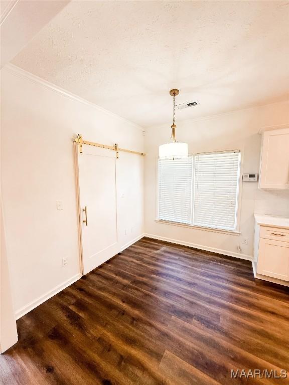 8524 Plantation Ridge Rd, Montgomery, AL 36116 - unfurnished dining area featuring dark wood-type flooring and ornamental molding