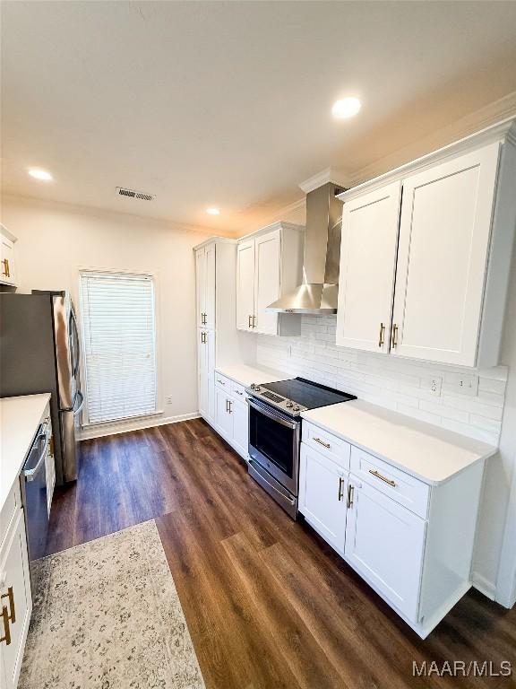 8524 Plantation Ridge Rd, Montgomery, AL 36116 - kitchen featuring wall chimney exhaust hood, appliances with stainless steel finishes, light countertops, white cabinetry, and recessed lighting