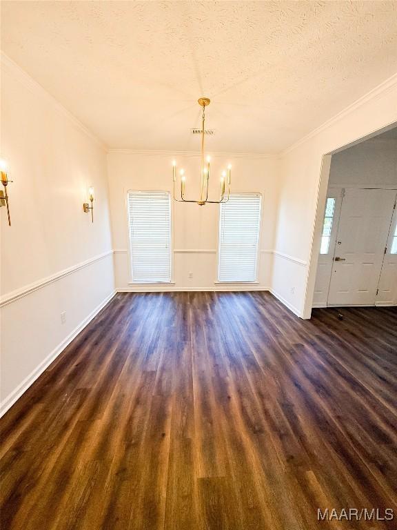 8524 Plantation Ridge Rd, Montgomery, AL 36116 - unfurnished dining area with a chandelier, ornamental molding, a textured ceiling, and dark wood-style flooring