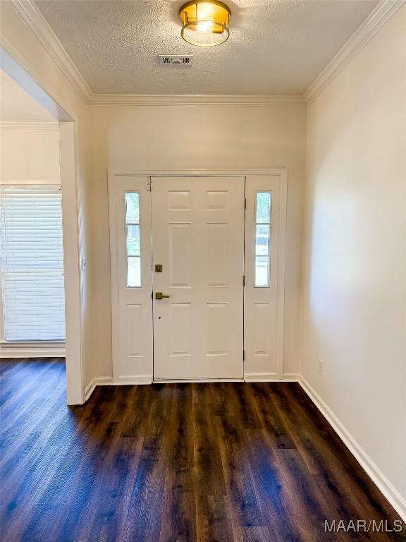 8524 Plantation Ridge Rd, Montgomery, AL 36116 - entrance foyer with dark wood finished floors, plenty of natural light, ornamental molding, and a textured ceiling