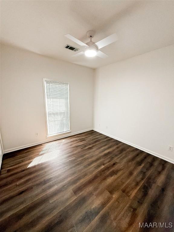 8524 Plantation Ridge Rd, Montgomery, AL 36116 - empty room with a ceiling fan and dark wood-style flooring