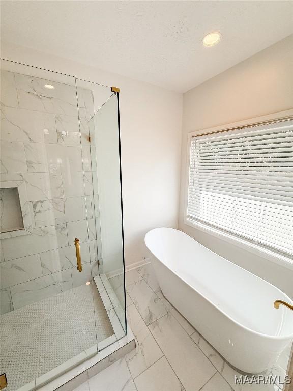 8524 Plantation Ridge Rd, Montgomery, AL 36116 - bathroom with marble finish flooring, a stall shower, a freestanding tub, and recessed lighting