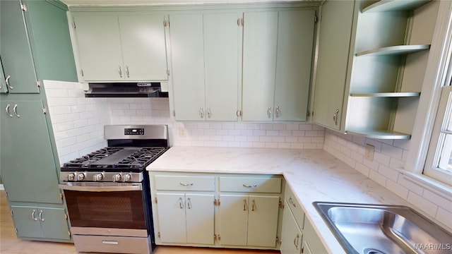 3427 Vance Ln, Montgomery, AL 36109 - kitchen with open shelves, stainless steel range with gas stovetop, decorative backsplash, and under cabinet range hood