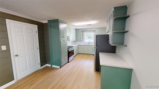 3427 Vance Ln, Montgomery, AL 36109 - kitchen with open shelves, green cabinets, light wood-style floors, light countertops, and white range with gas stovetop