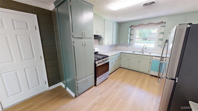 3427 Vance Ln, Montgomery, AL 36109 - kitchen with stainless steel appliances, open shelves, light wood-style floors, backsplash, and light countertops
