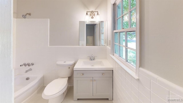 3427 Vance Ln, Montgomery, AL 36109 - full bathroom featuring tile walls, vanity, wainscoting, and  shower combination