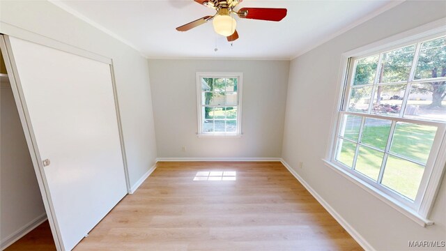 3427 Vance Ln, Montgomery, AL 36109 - unfurnished bedroom with multiple windows, light wood finished floors, ornamental molding, a closet, and ceiling fan