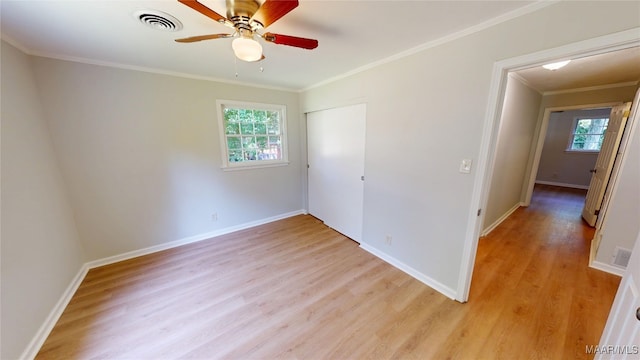 3427 Vance Ln, Montgomery, AL 36109 - unfurnished bedroom with multiple windows, light wood-style flooring, ornamental molding, a closet, and ceiling fan