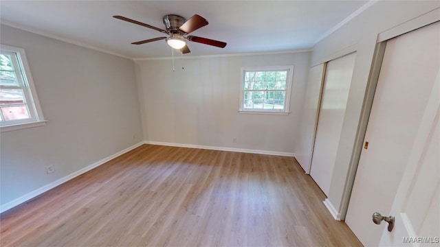 3427 Vance Ln, Montgomery, AL 36109 - unfurnished bedroom featuring crown molding, light wood finished floors, multiple closets, and ceiling fan