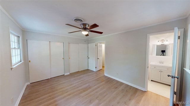 3427 Vance Ln, Montgomery, AL 36109 - unfurnished bedroom with multiple closets, crown molding, light wood-type flooring, ensuite bath, and ceiling fan