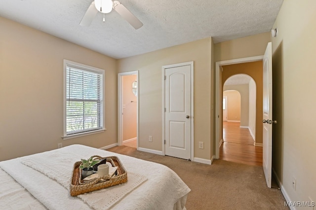 2014 Commodore St, Montgomery, AL 36106 - bedroom with arched walkways, a textured ceiling, carpet, and ceiling fan