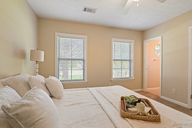 2014 Commodore St, Montgomery, AL 36106 - bedroom with multiple windows, carpet floors, a textured ceiling, and a ceiling fan