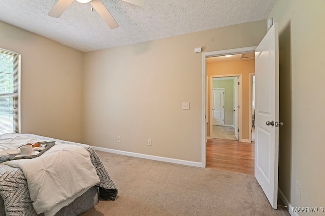 2014 Commodore St, Montgomery, AL 36106 - bedroom featuring a textured ceiling, light carpet, and a ceiling fan