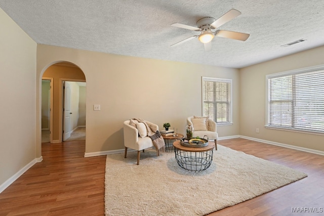 2014 Commodore St, Montgomery, AL 36106 - living area with arched walkways, ceiling fan, wood finished floors, and a textured ceiling