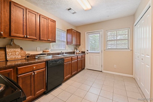 2014 Commodore St, Montgomery, AL 36106 - kitchen with dishwasher, range, a textured ceiling, brown cabinetry, and light tile patterned flooring