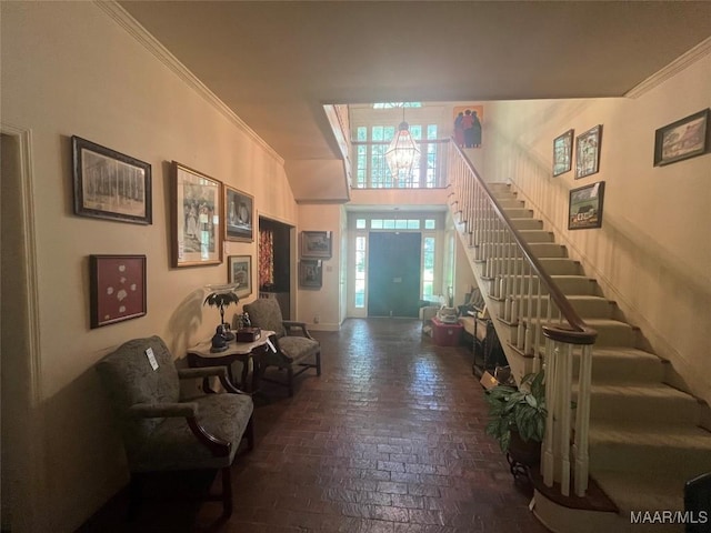 1682 Landline Rd, Selma, AL 36701 - foyer featuring brick flooring, stairway, crown molding, and a chandelier