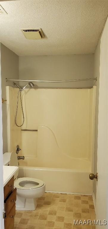 3152 Gentilly Ct, Montgomery, AL 36116 - full bathroom featuring washtub / shower combination, vanity, a textured ceiling, and tile patterned floors