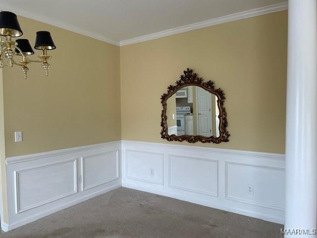 8824 Templeton Ct, Montgomery, AL 36117 - carpeted empty room featuring wainscoting, ornamental molding, and decorative columns