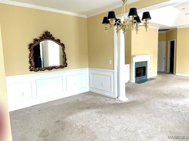 8824 Templeton Ct, Montgomery, AL 36117 - unfurnished living room featuring a chandelier, carpet, ornamental molding, a wainscoted wall, and a fireplace with flush hearth