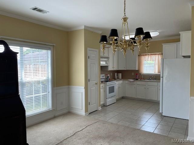 8824 Templeton Ct, Montgomery, AL 36117 - kitchen with white appliances, a chandelier, light colored carpet, white cabinetry, and light tile patterned floors