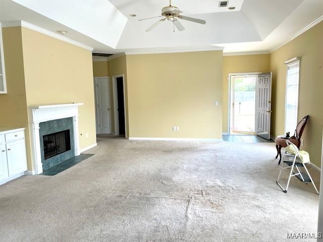8824 Templeton Ct, Montgomery, AL 36117 - unfurnished living room featuring a tray ceiling, ornamental molding, a ceiling fan, light colored carpet, and a fireplace