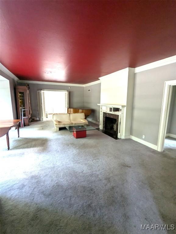 1672 Gilmer Ave, Montgomery, AL 36104 - unfurnished living room featuring carpet, ornamental molding, and a fireplace with flush hearth