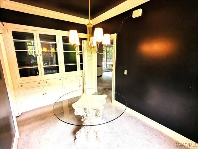 1672 Gilmer Ave, Montgomery, AL 36104 - unfurnished dining area featuring carpet flooring, a chandelier, and ornamental molding