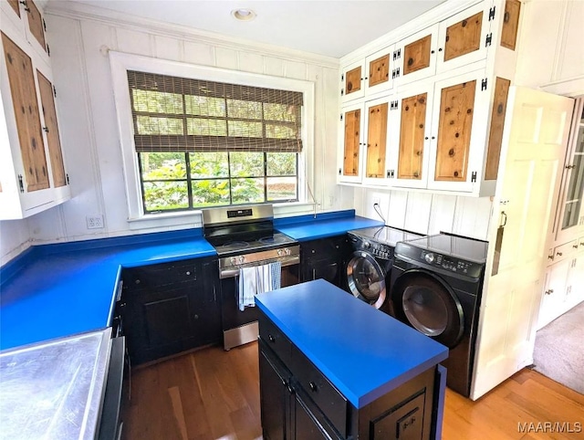1672 Gilmer Ave, Montgomery, AL 36104 - kitchen with electric stove, independent washer and dryer, wood finished floors, crown molding, and a center island