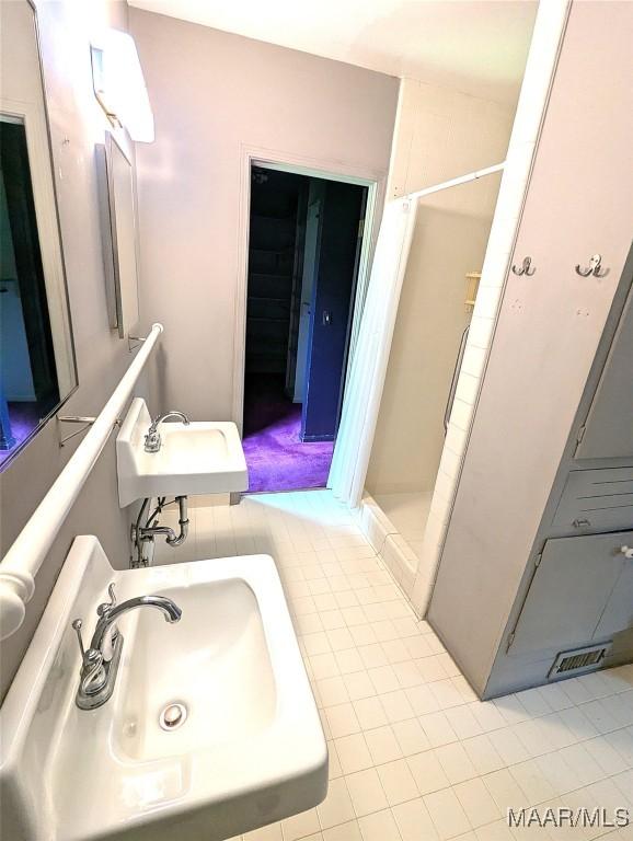 1672 Gilmer Ave, Montgomery, AL 36104 - full bathroom featuring a sink and a stall shower