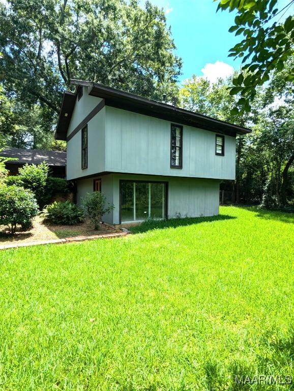 1672 Gilmer Ave, Montgomery, AL 36104 - back of house featuring a yard