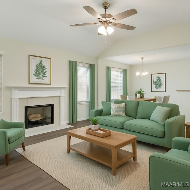 75 Gaines Ct, Wetumpka, AL 36092 - living area with wood finished floors, a chandelier, a tiled fireplace, lofted ceiling, and a ceiling fan