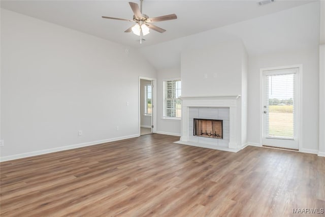 75 Gaines Ct, Wetumpka, AL 36092 - unfurnished living room with healthy amount of natural light, ceiling fan, vaulted ceiling, a tile fireplace, and light wood-style flooring