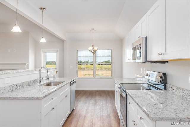 75 Gaines Ct, Wetumpka, AL 36092 - kitchen with appliances with stainless steel finishes, vaulted ceiling, dark wood-type flooring, white cabinetry, and light stone counters