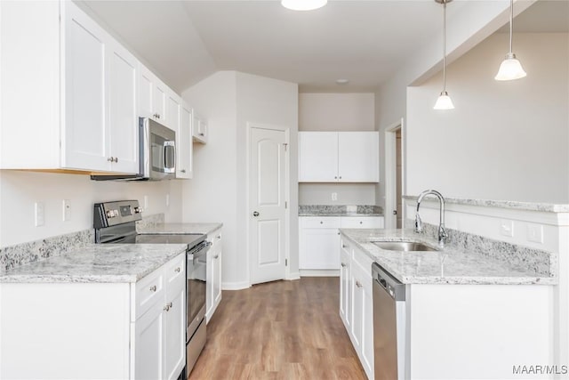 75 Gaines Ct, Wetumpka, AL 36092 - kitchen with appliances with stainless steel finishes, light stone counters, light wood-style flooring, and white cabinets
