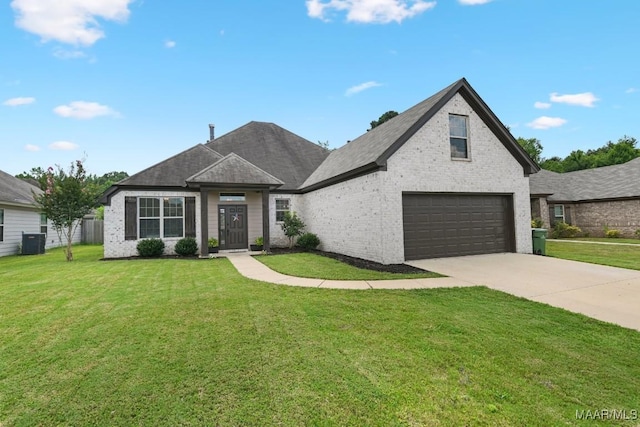 905 Overture Dr, Montgomery, AL 36117 - view of front of property featuring a front yard, concrete driveway, an attached garage, and brick siding