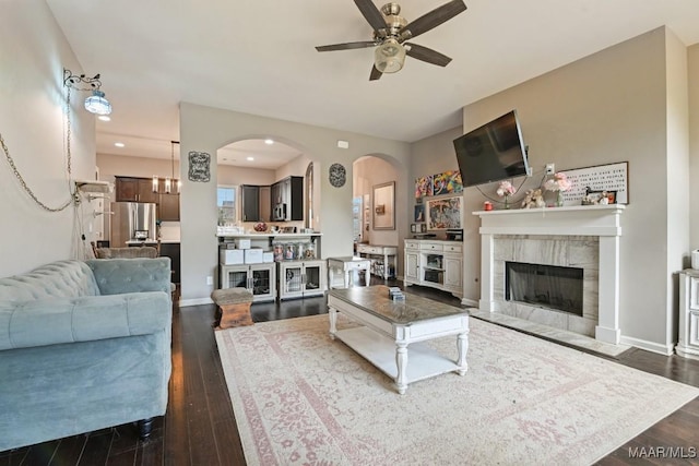 905 Overture Dr, Montgomery, AL 36117 - living area featuring dark wood finished floors, ceiling fan, arched walkways, a tiled fireplace, and recessed lighting