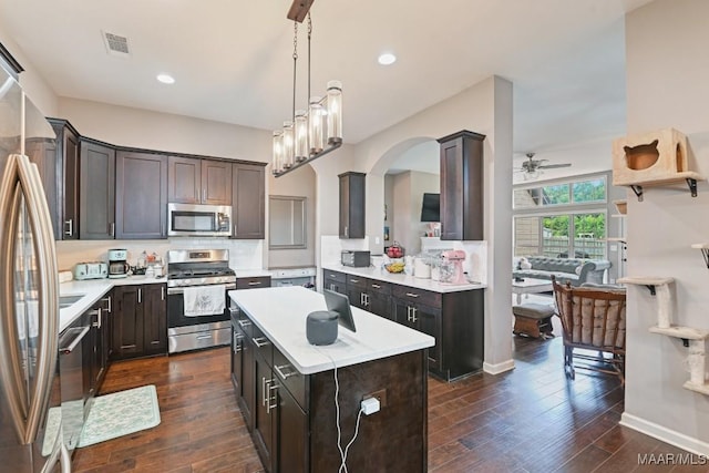 905 Overture Dr, Montgomery, AL 36117 - kitchen featuring stainless steel appliances, a ceiling fan, dark wood-style floors, dark brown cabinets, and a kitchen island
