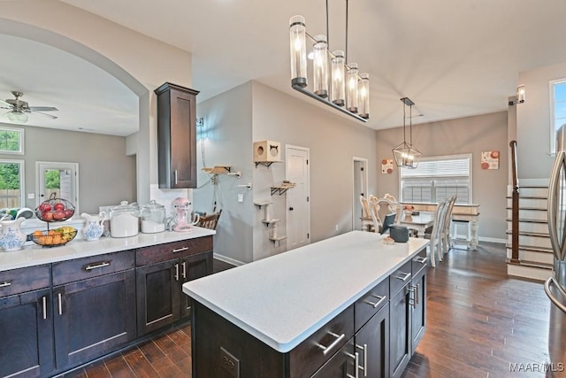 905 Overture Dr, Montgomery, AL 36117 - kitchen with a ceiling fan, dark wood-style floors, light countertops, pendant lighting, and arched walkways