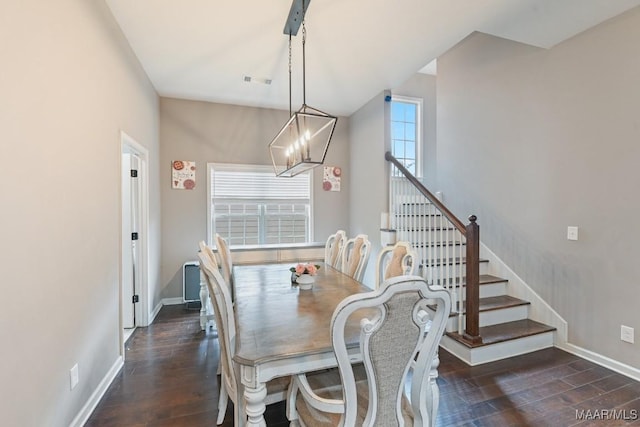 905 Overture Dr, Montgomery, AL 36117 - dining space featuring dark wood finished floors, a chandelier, and stairs