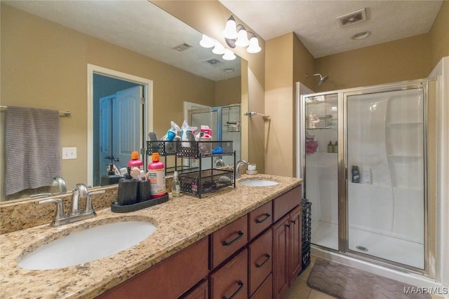 6209 Sycamore Dr, Montgomery, AL 36117 - bathroom featuring a shower stall, double vanity, and tile patterned floors