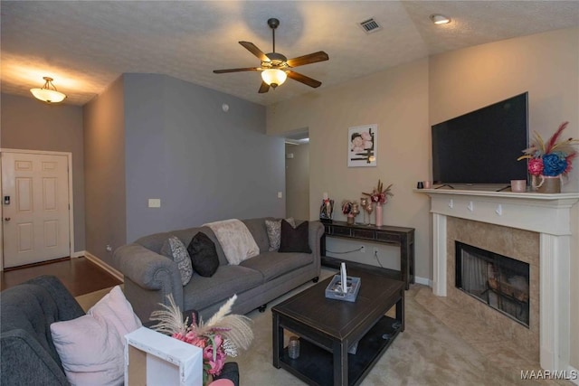 6209 Sycamore Dr, Montgomery, AL 36117 - living area with ceiling fan, a tiled fireplace, and carpet floors