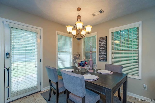 6209 Sycamore Dr, Montgomery, AL 36117 - dining area with a chandelier, light tile patterned floors, and plenty of natural light