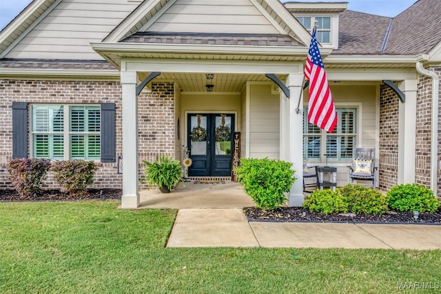 235 Midland Dr, Wetumpka, AL 36093 - view of exterior entry featuring brick siding, french doors, and a lawn