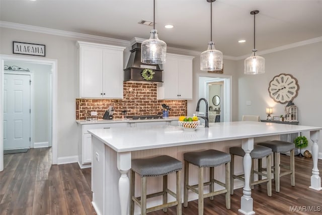 235 Midland Dr, Wetumpka, AL 36093 - kitchen featuring wall chimney exhaust hood, white cabinetry, tasteful backsplash, light countertops, and ornamental molding
