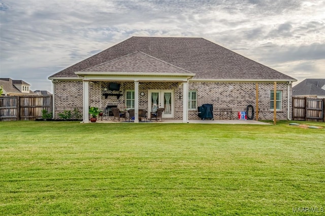 235 Midland Dr, Wetumpka, AL 36093 - back of property with brick siding, a patio, a fenced backyard, and a shingled roof