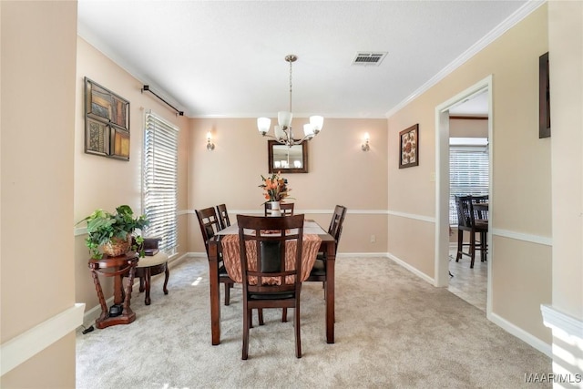 1825 W Astrid Pl, Montgomery, AL 36117 - dining area with a chandelier, light carpet, and crown molding