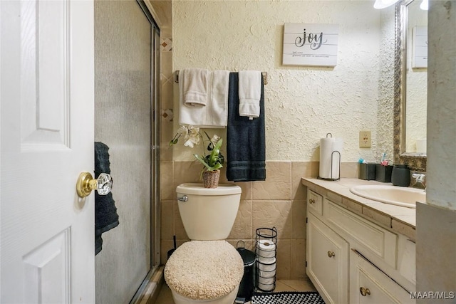 1825 W Astrid Pl, Montgomery, AL 36117 - full bath with vanity, a shower stall, tile walls, and tile patterned floors