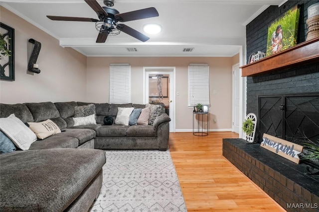 1825 W Astrid Pl, Montgomery, AL 36117 - living area with ornamental molding, a fireplace, light wood-type flooring, and a ceiling fan