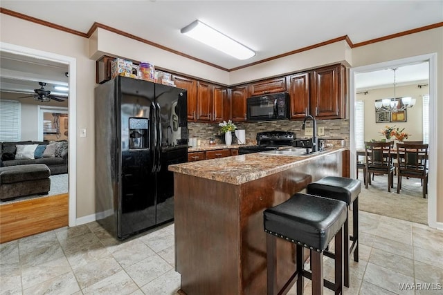 1825 W Astrid Pl, Montgomery, AL 36117 - kitchen featuring black appliances, decorative backsplash, ornamental molding, a kitchen breakfast bar, and a ceiling fan