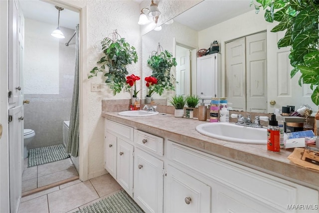 1825 W Astrid Pl, Montgomery, AL 36117 - full bathroom with double vanity, a textured wall, a shower with curtain, and tile patterned floors